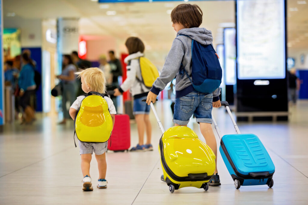 child at airport with parents illustrating can I take children out of the country without permission?